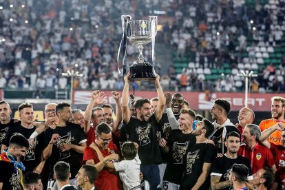 Jugadores del Valencia levantan la Copa que le ganaron ayer al Barcelona, en la final disputada en el Benito Villamarín.