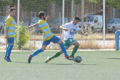 Un jugador del Balàfia avança amb la pilota davant de la pressió d’un rival.