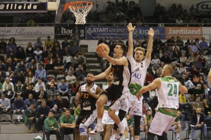 El base gallego Adrián Chapela penetra a canasta ante la oposición de Tautvydas Sabonis y Evaldas Zabas.