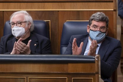 El ministro de Universidades, Manuel Castells (izquierda), y el ministro de Inclusión, Seguridad Social y Migraciones, José Luis Escrivá, durante una sesión en el Congreso.