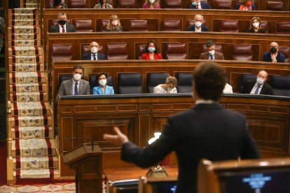 Pedro Sánchez y Pablo Casado, de espaldas, durante su enfrentamiento de ayer en el Congreso.