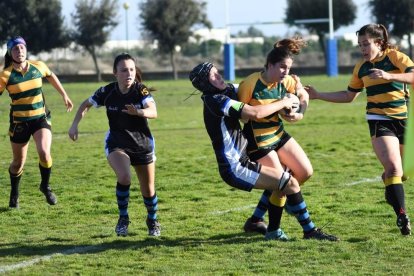 Una jugadora del CE Inef Lleida és placada per una rival durant un partit de la passada temporada.