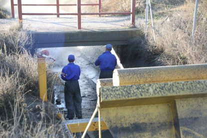 Operaris treballant ahir en el condicionament i neteja a la séquia Major de Pinyana a Lleida.