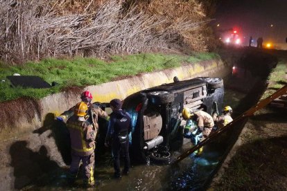 Operativo de los Bomberos para rescatar el vehículo caído al canal de Pinyana la noche del domingo.