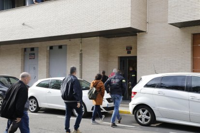Mossos i advocats entrant ahir al portal de l’edifici de Balàfia en què es va escorcollar un pis.