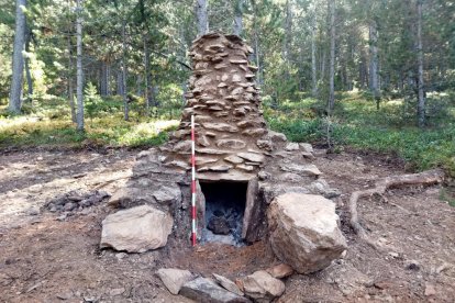 Vista frontal de la reproducció a escala 1:1 del forn excavat, feta al costat del jaciment original, al bosc de Virós, al municipi d'Alins.