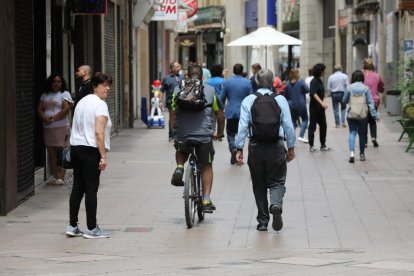 Un ciclista per l’Eix Comercial durant el dia, cosa que vulnera l’ordenança de mobilitat,