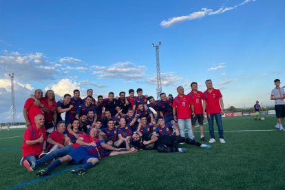 Jugadores, técnicos y directivos posan en el césped celebrando el histórico ascenso.