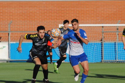 Nico Magno pugna per una pilota aèria amb un rival de la Guineueta, ahir durant el partit al Municipal de Mollerussa.