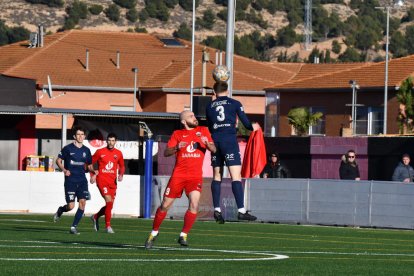 Domingo, de l’Atlètic Lleida, remata una pilota aèria amb l’oposició de l’atacant local Vendrell.