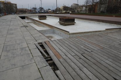 Pavimento en mal estado. Una parte de las baldosas de madera del cubrimiento de las vías, entre la calle Rosa Parks y Prat de la Riba, están levantadas y en mal estado.