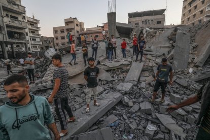 Palestins inspeccionant un dels edificis enderrocats pels atacs israelians.