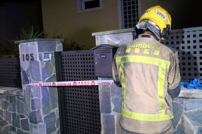 Un bomber precinta l’entrada de la casa sinistrada.