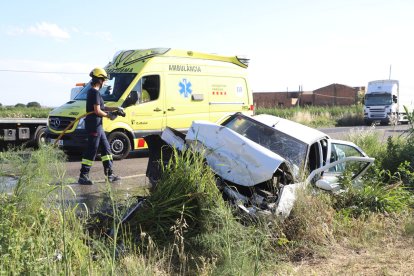 Una bombera i efectius del SEM treballant ahir en el xoc a l’N-IIa a Lleida.