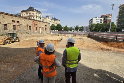 La consellera de Territori, d’esquena, mira els terrenys en els quals s’edificarà la nova estació d’autobusos, al costat de la de trens.