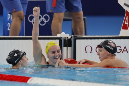 La nadadora australiana Ariarne Titmus celebra la victòria flanquejada per McIntosh i Ledecky.