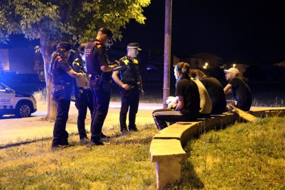 Agents dels Mossos i de la Policia Local de Mollerussa parlen amb un grup de joves