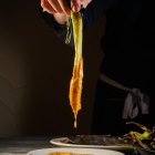 La tradició marca que els calçots es mengin dempeus.