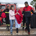 Varios militares de la Unidad Militar de Emergencia (UME) trasladan a una mujer rescatada de su casa inundada en Los Alcázares, Murcia.