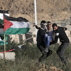 Diversos manifestants palestins retiren un jove que va resultar ferit a la frontera entre Israel i Gaza.