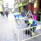 Un operario de Aigües Lleida trabajando en el alcantarillado en la calle Mayor.