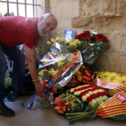 Un membre de la Penya Barcelonista de Lleida diposita l'ofrena floral de la Diada al Roser.