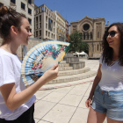 Dos joves poloneses intenten apaivagar la calor a la plaça Sant Joan de Lleida.