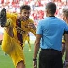 Piqué hace un gesto al árbitro en El Sadar intentando demostrar que la mano no fue intencionada.