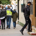 La Policía, con el niño que encontró el cuerpo de su madre, ayer.