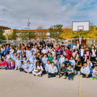 Los alumnos del IE Torre Queralt, junto a los jugadores del Força Lleida durante la visita del martes en el patio del centro educativo.