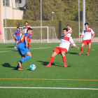 Un jugador del Térmens controla la pilota davant la presència de diversos defenses locals durant una acció del partit.