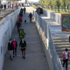 Un dels accessos a la canalització del riu Segre a Lleida, amb ciclistes i passejants, ahir.
