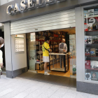 La librería Caselles de Lleida ayer, atendiendo a los clientes con cita previa en la puerta del comercio.