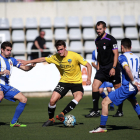 Un jugador del Lleida controla el balón, acosado por dos rivales, durante el partido de ayer.