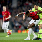 Sergio Busquets pugna con el jugador del Manchester Pogba, en una acción del partido de ayer.