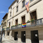 Bandera multicolor al balcó de l’ajuntament de les Borges i façana de la Paeria de Lleida il·luminada amb els colors de l’arc de Sant Martí.