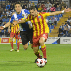 Juanto Ortuño avança amb la pilota agafat per un jugador de l’Hèrcules.