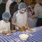 Dos niños en el taller de panadería del Gremi de Forners.