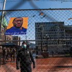 Un policia treu imatges en favor de George Floyd.