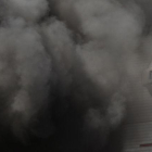 Entrada de la fábrica de Nissan en la Zona Franca de Barcelona, rodeada por el humo, durante las protestas del año pasado