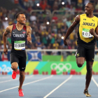 Bolt corriendo junto a De Grasse, ausente en el Mundial por lesión.