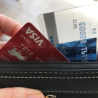Una persona retira una tarjeta de su bolso de mano este miércoles en Miami, Florida