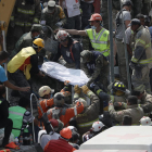 Voluntarios y equipos de rescate sacan cuerpos de entre los escombros en México.