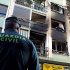 Un agente de la Guardia Civil observa la vivienda incendiada ubicada en el municipio de Burriana.