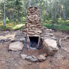 Vista frontal de la reproducción a escala 1:1 del horno excavado, hecha al lado del yacimiento original, en el bosque de Virós, en el municipio de Alins.