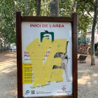 Un cartel con una pintada enorme en un parque de la ciudad. 