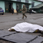 El cuerpo de una persona fallecida por los combates yace en una calle en el  Donbás.