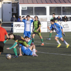 Un jugador de La Seu comete una falta sobre otro del Cervera ante la mirada del árbitro.