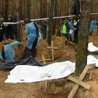 Treballadors exhumant els cossos a la fossa comuna trobada a la ciutat d’Izium.