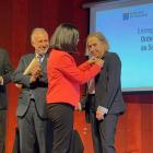 La ministra de Sanidad, Carolina Darias, pone el galardón a la pediatra María Teresa Cotonat.